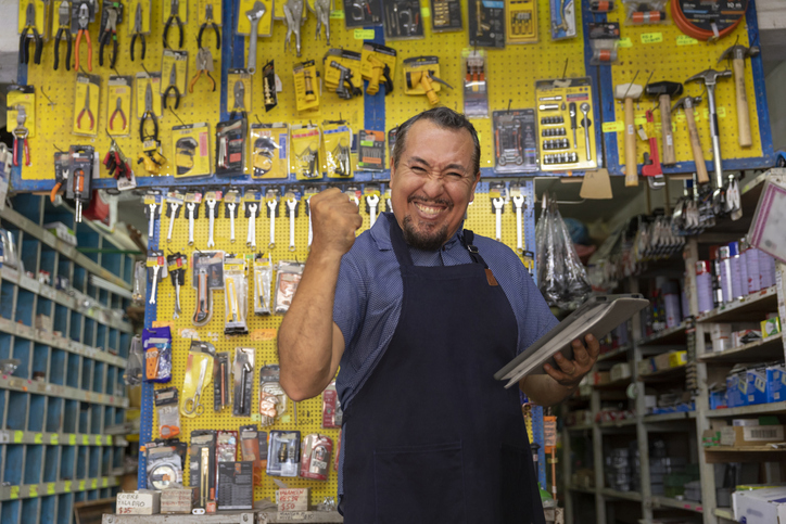 Adult entrepreneur man with apron in her business,